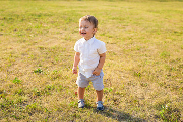 little boy playing in summer nature