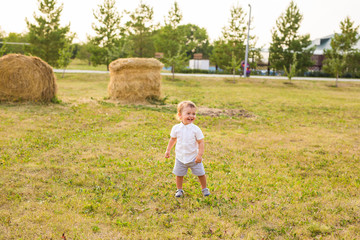 little boy playing in summer nature
