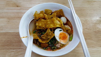 Hot and spicy instant noodle and fork on the table
