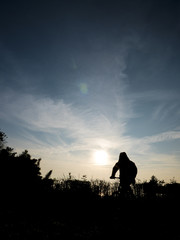 Fototapeta premium silhouette of man on mountain bike at sunset