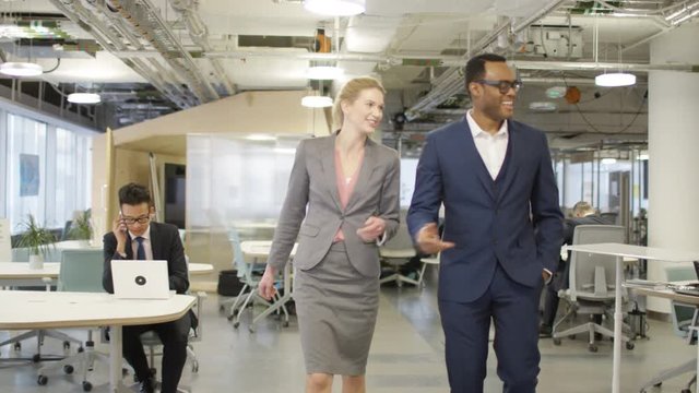  Smart executive business managers walking through modern office