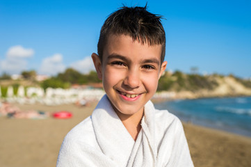 boy with a towel on the beach