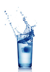 Splash in glass of blue water with ice cube