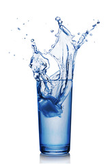 Splash in glass of blue water with ice cube