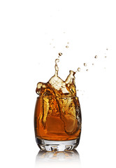 Splash in glass of scotch whiskey with ice cube