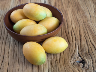 marian plum in wooden bowl