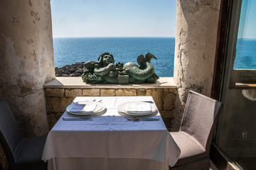 Restaurant mit gedecktem Tisch und Meerblick in Gallipoli, Italien