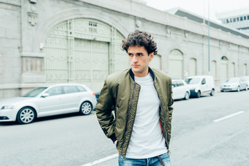 Handsome young man outdoor in the city looking away serious - customer, attitude, indipendent...