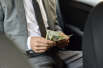 man counting dollar bills