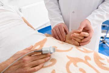 Obraz na płótnie Canvas Physician keeping hand of ill male