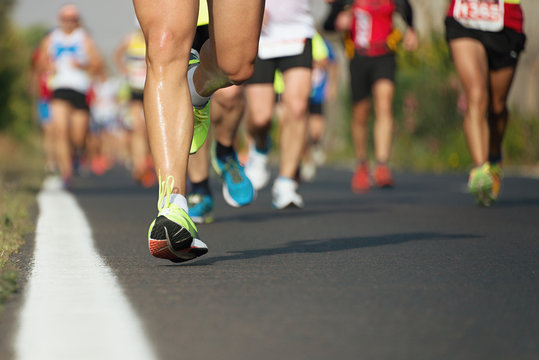 Marathon running race, runners feet on road