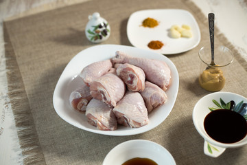 The chicken leg baked in an oven on a glass plate on a gray background