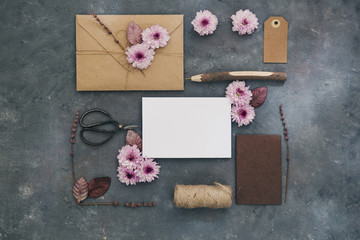 Stylish branding mockup with flowers  to display your artworks. Cute vintage mock up on wooden background.
