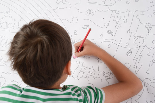 Little boy draw and painting pencil color on the paper home activities
