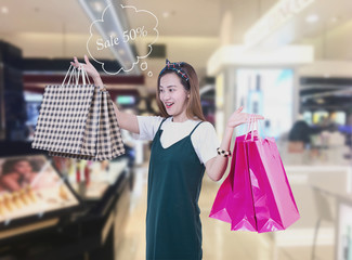 Beauty Woman with Shopping Bags in Shopping Mall. Shopper. Sales. Shopping Center
