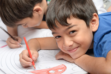 Little boy draw and painting pencil color on the paper home activities