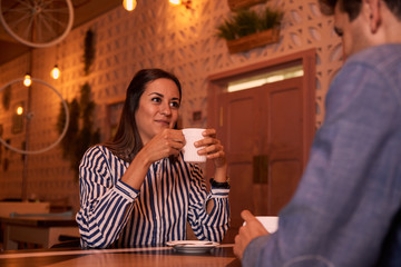 Happy young couple sipping their coffee