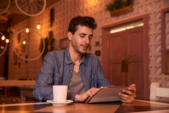 Pensive young man sitting in restaurant