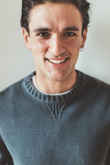 Fototapeta premium Portrait of handsome young man indoor looking camera - customer, serene, attitude concept