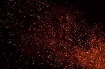 Sparks from a bonfire against the background of the night sky