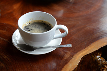 Coffee cup for breakfast with spoon on the wooden table