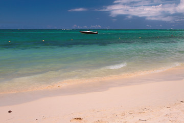 Beach, motor boat, ocean. Trou aux Biches, Mauritius