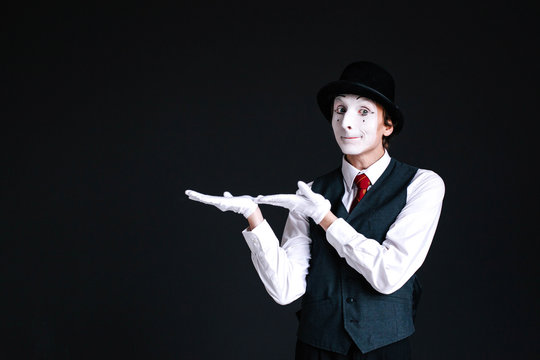 Mime holds something invisible on his palms