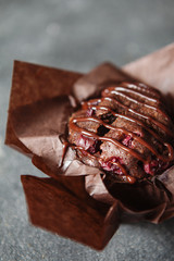 Dark chocolate muffin with cherry and sauce
