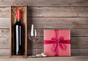 Red wine bottle, gift box and wine glass