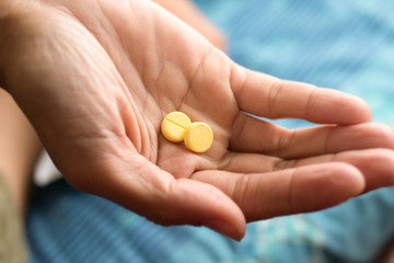 Medicine two  pill in women hand.