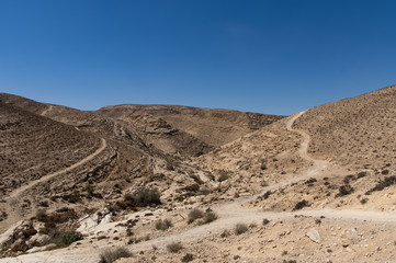 A hilly stone desert, with roads.