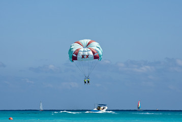 Couple flys on a parachute