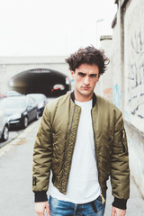 Waist up of handsome young man outdoor in the city looking camera serious - customer, attitude,...