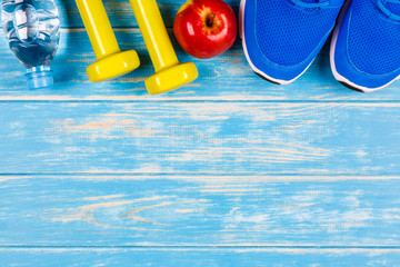 View of concept of fitness and dieting plan on blue wood background.