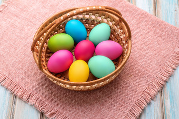 Basket with colourful hand-painted Easter eggs