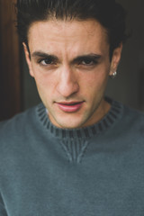Fototapeta premium Portrait of handsome young man indoor looking camera - customer, serene, attitude concept
