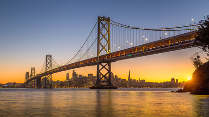 Fototapeta na wymiar San Francisco skyline with Oakland Bay Bridge at sunset, California, USA