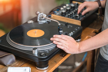 Dj play music at hip hop party.Turntable vinyl record player,analog sound technology for disc jockey to scratch vinyl records and mix tracks