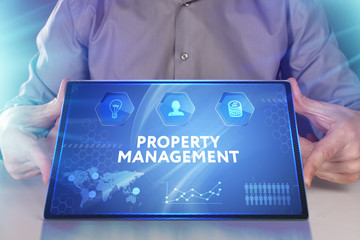 Business, Technology, Internet and network concept. Young businessman working on a virtual screen of the future and sees the inscription: Property management