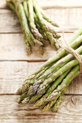 Bunch of green asparagus on grey wooden table