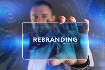 Business, Technology, Internet and network concept. Young businessman working on a virtual screen of the future and sees the inscription: Rebranding