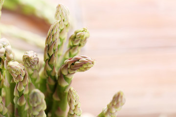 Green asparagus on brown wooden table