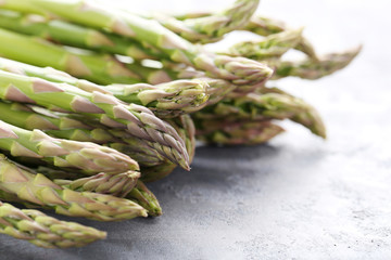 Green asparagus on grey wooden table