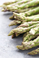 Green asparagus on grey wooden table