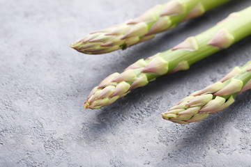Green asparagus on grey wooden table