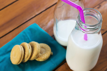 Milk and cookies on wooden boards