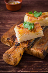 Traditional Georgian cheese layer pie Achma on wooden background. Selective focus