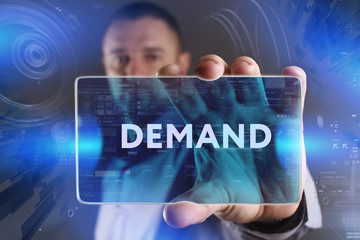 Business, Technology, Internet and network concept. Young businessman working on a virtual screen of the future and sees the inscription: Demand