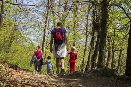 Parents with children walking by hiking trail
