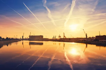 Poster de jardin Porte Sunrise over crane silhouettes in Szczecin harbor, Poland.